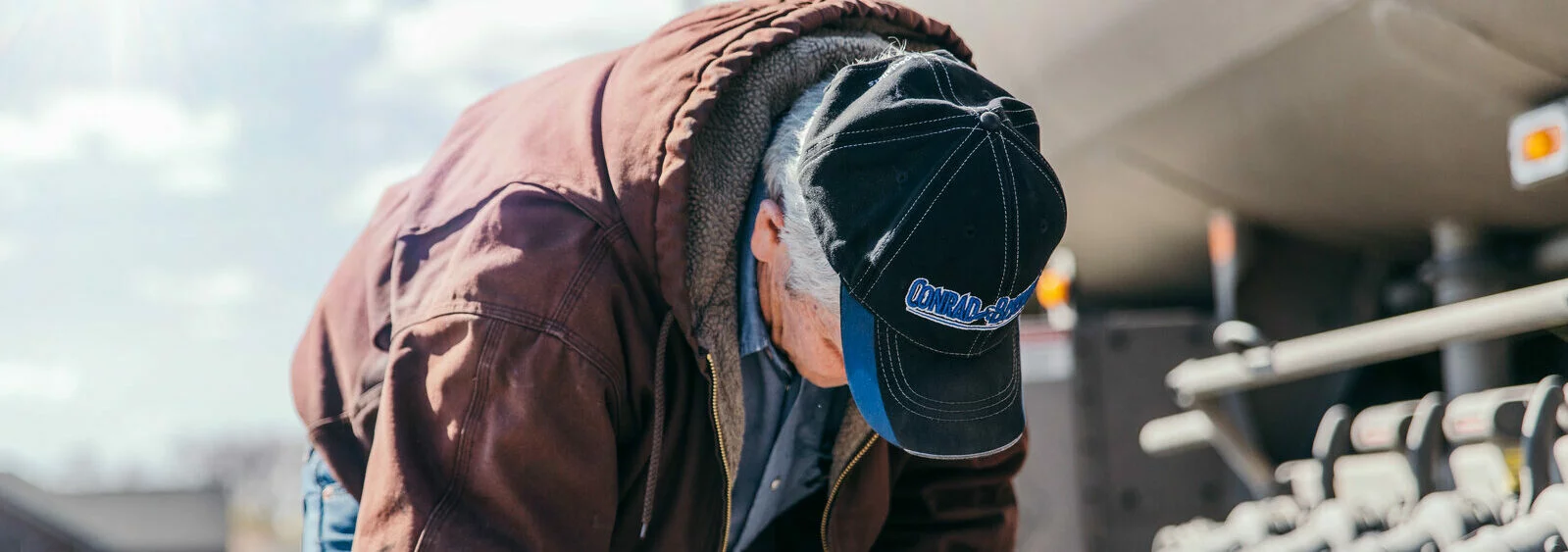 Conrad and Bischoff employee wearing a company hat during work.