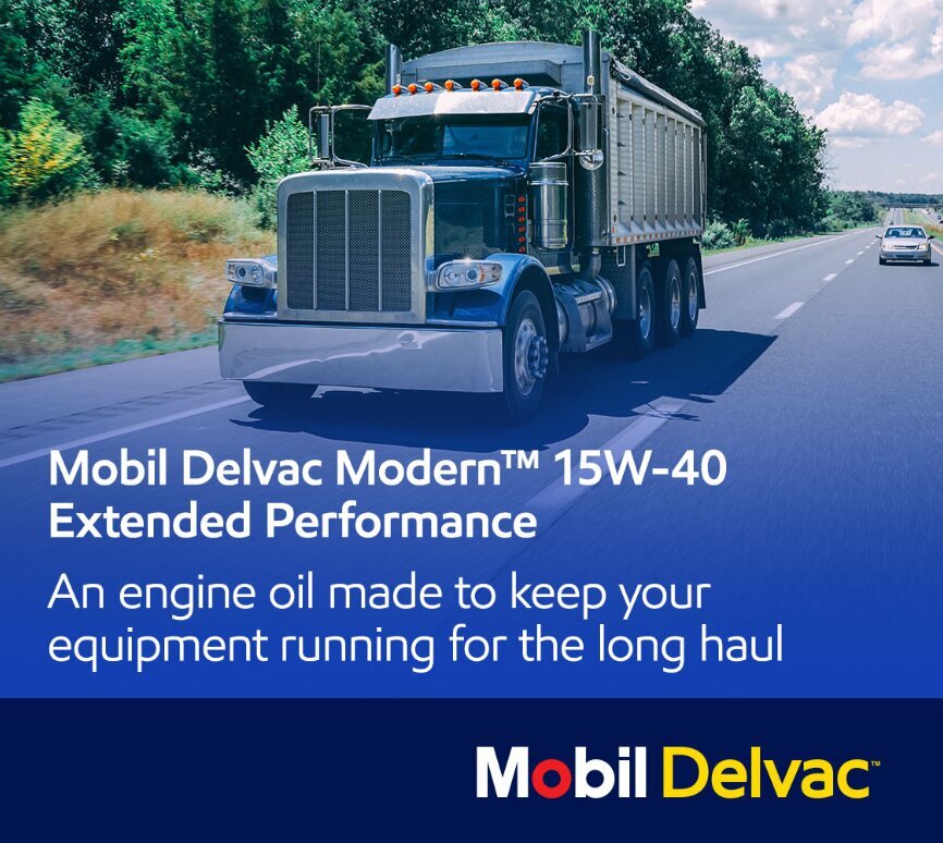 A long-haul truck drives on a highway promoting Mobil Delvac Modern™ 15W-40 EP, a high-performance engine oil for extended equipment life.